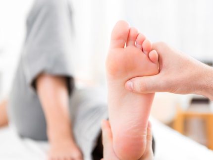 Young attractive physiotherapist doing reflexology on a patient feet ?brizy media=34098&brizy crop=iW%3D372%26iH%3D248%26oX%3D20%26oY%3D0%26cW%3D331%26cH%3D248