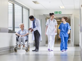 Doctors Nurse senior Female Patient in Hospital Corridor Fotolia 56555344 Subscription Monthly M 1280x853 1