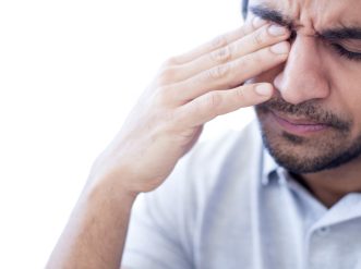 Man rubbing his right eye GettyImages 1169059190
