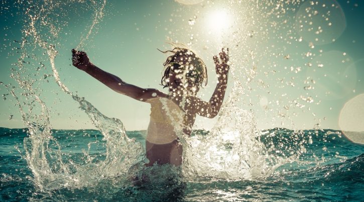 Happy,Child,Playing,In,The,Sea.,Kid,Having,Fun,Outdoors. bambini.mare