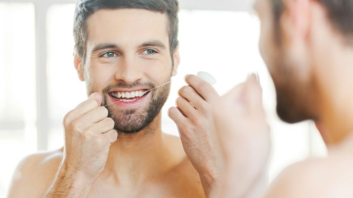cleaning teeth with dental floss