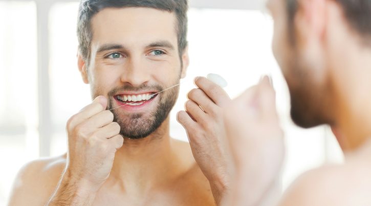 cleaning-teeth-with-dental-floss- cleaning teeth with dental floss