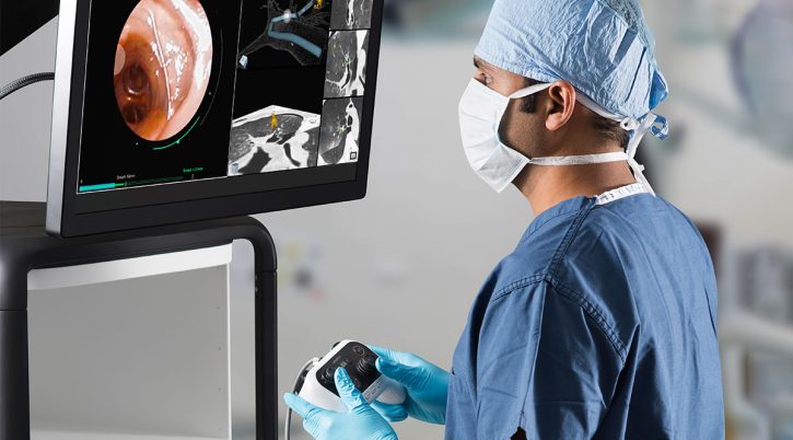 monarch_bronchoscopy_-_physician_using_controller_to_drive_monarch_platform-1 monarch bronchoscopy physician using controller to drive monarch platform 1