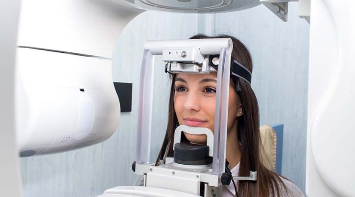Girl taking digital 3D panoramic dental x-ray. ortopantomografia emicenter napoli