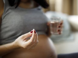 Pregnant woman taking pill at home paracetamolo in gravidanza