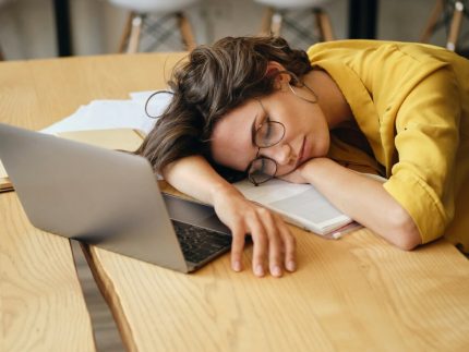young-tired-woman-in-eyeglasses-fall-asleep-on-desk-with-laptop-and-documents-under-head-at-workplace ?brizy media=32557&brizy crop=iW%3D372%26iH%3D248%26oX%3D20%26oY%3D0%26cW%3D331%26cH%3D248